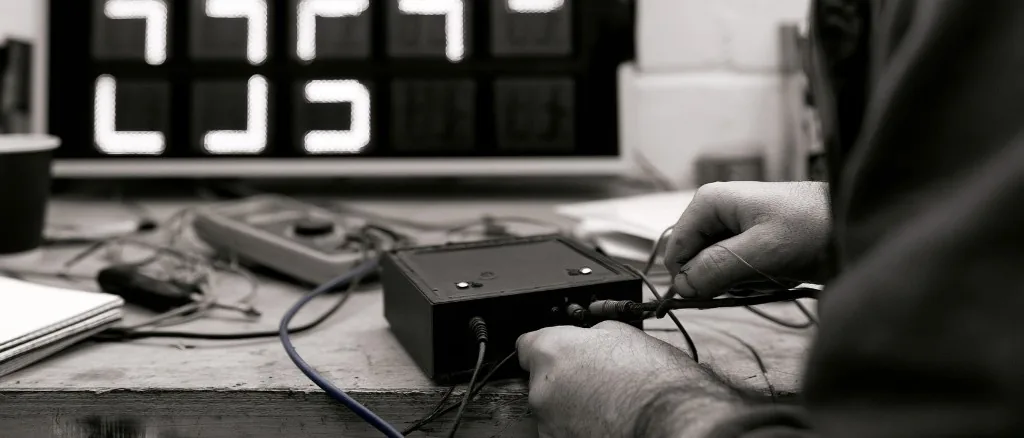 The fuel display controller PCB in its enclosure on a workbench.